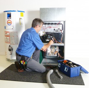 Technician Cleaning Furnace